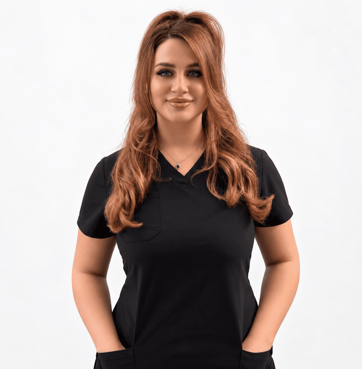 Abby Perdue, massage therapist, smiling in black scrubs